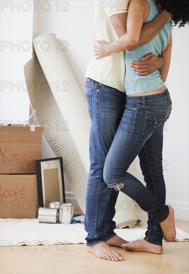 Couple hugging in living room