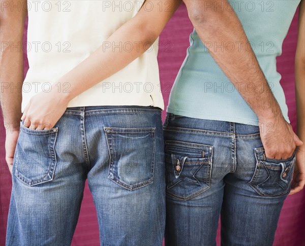 Couple with hands in each other's rear jeans pockets