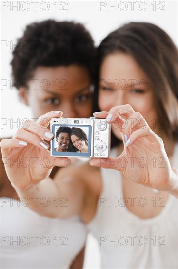 Friends taking self-portrait with digital camera