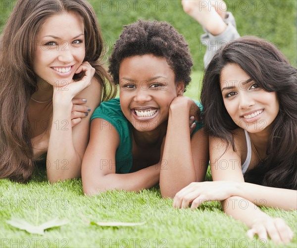 Friends laying and relaxing in grass