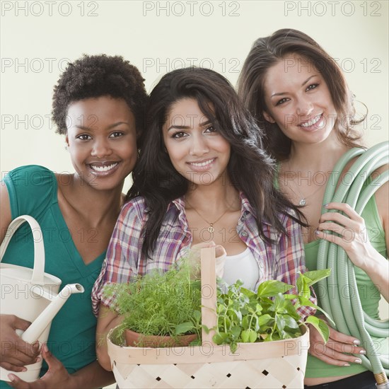 Friends holding gardening supplies