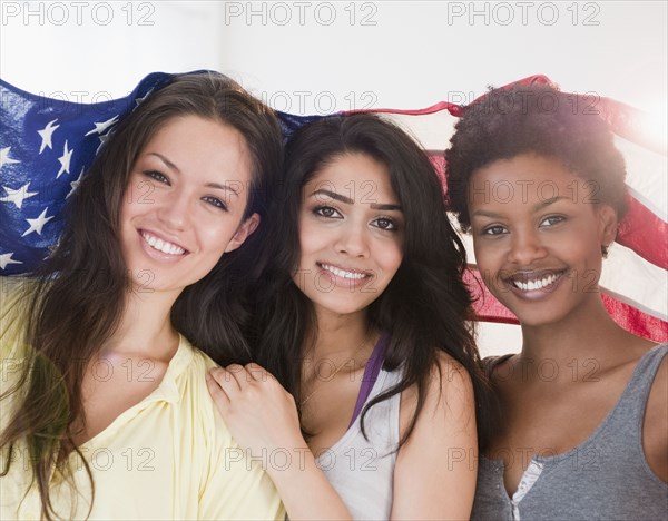 Friends wrapping themselves in American flag