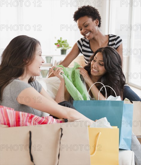 Friends examining shopping purchases