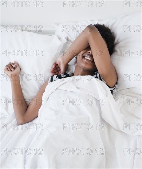 African woman laying in bed