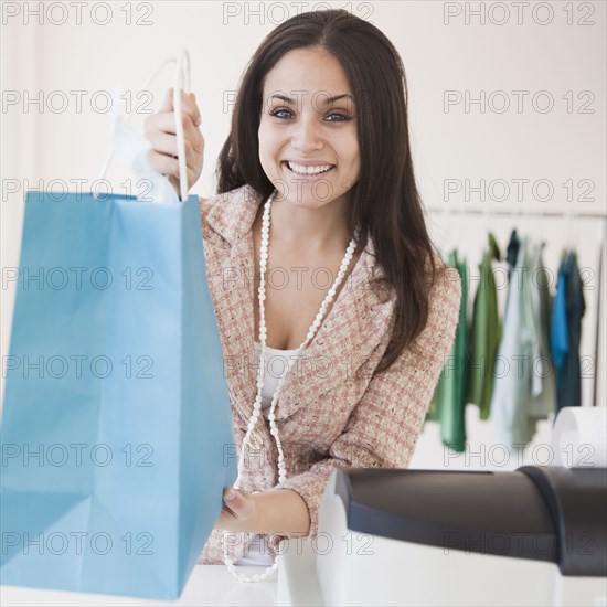 Mixed race woman working on clothing shop