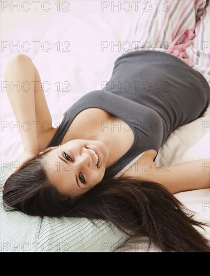 Mixed race woman laying on bed