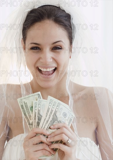 Bride holding handful of money