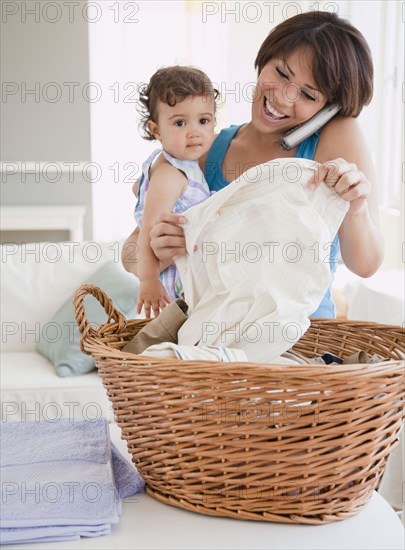 Hispanic mother holding daughter