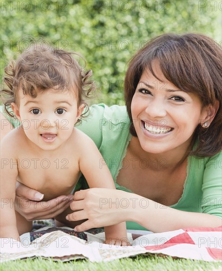 Hispanic mother and daughter in backyard