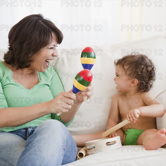 Hispanic mother and daughter making music