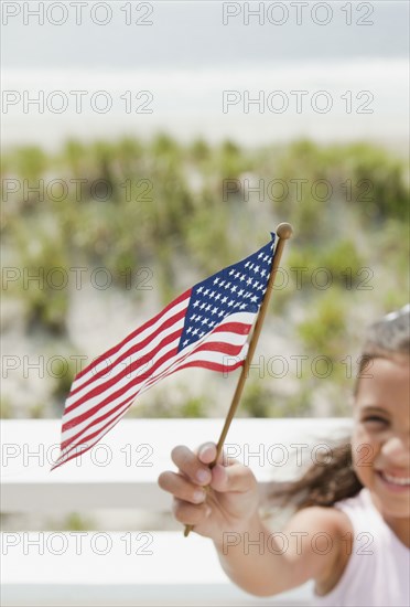 Hispanic girl holding American flag