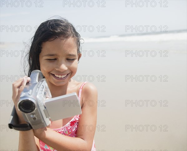 Hispanic girl using video camera