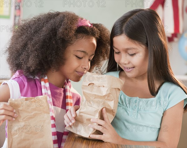 School girls looking into lunch bag