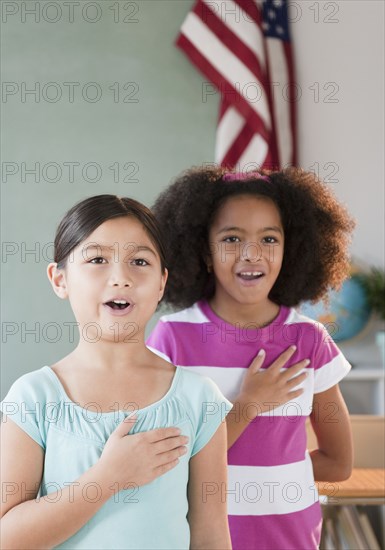 School girls pledging allegiance to the flag