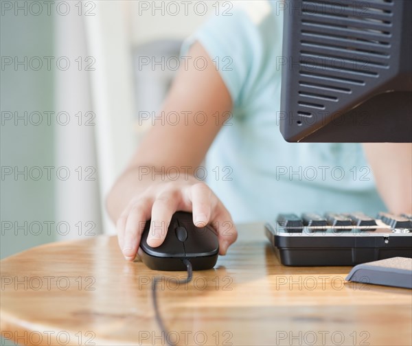 Mixed race girl using computer