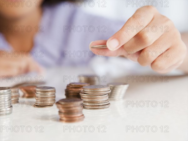 Hispanic girl stacking coins