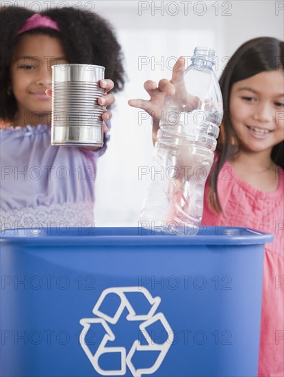 Girls recycling can and bottle