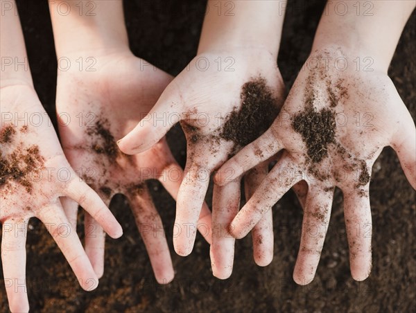 Girls holding dirt