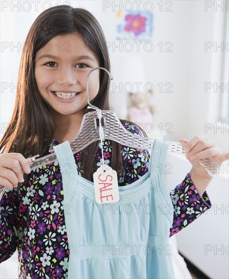 Mixed race girl shopping for dress