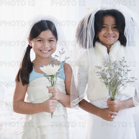 Girls dressing up in wedding dress