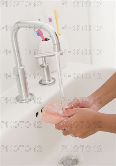 Hispanic girl washing hands