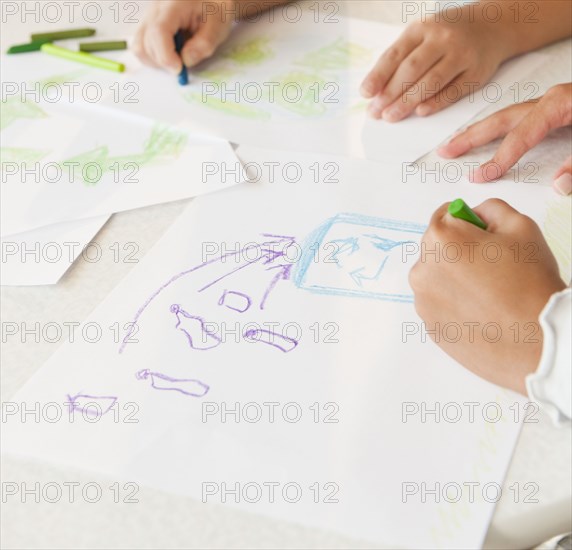 Girls drawing recycling pictures