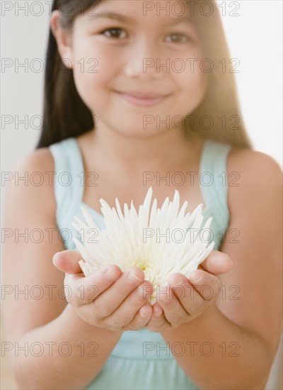 Mixed race girl holding flower