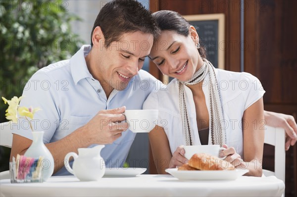 Hispanic couple having breakfast in cafe