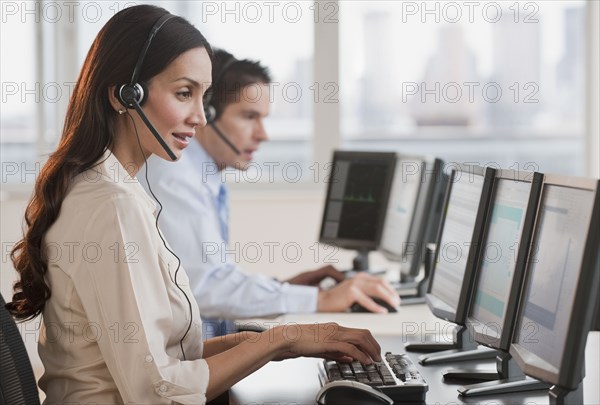 Hispanic businesswoman working on computer