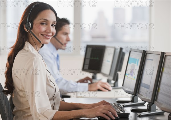 Hispanic businesswoman working on computer