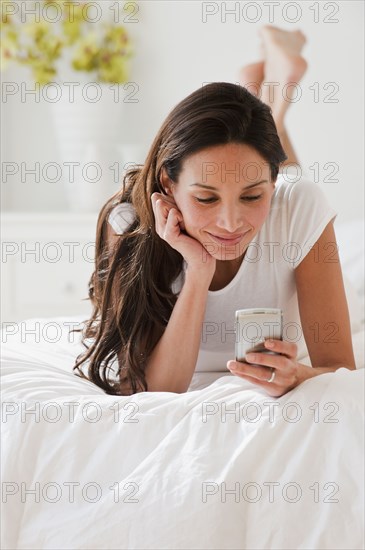 Hispanic woman looking at cell phone