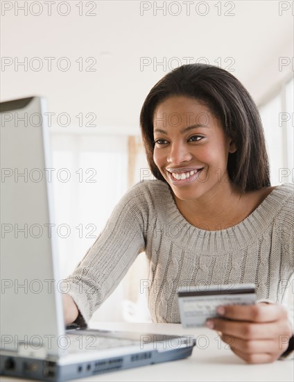 Mixed race woman shopping online with credit card