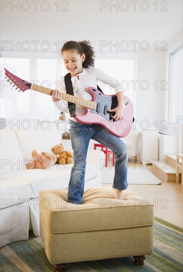 Hispanic girl playing guitar