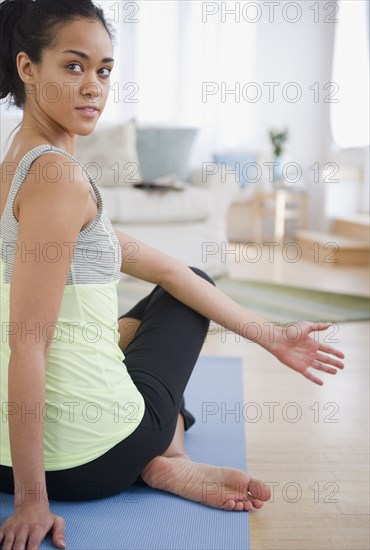 Mixed race woman practicing yoga