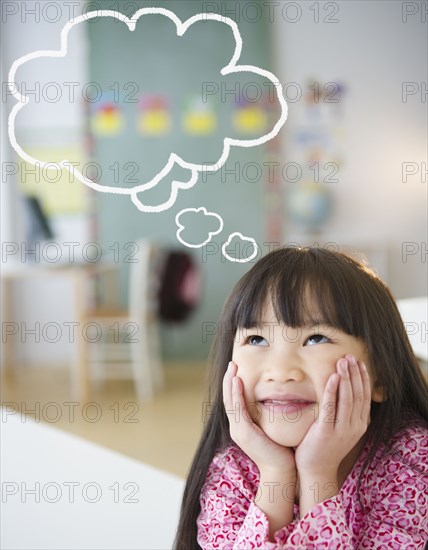 Chinese girl with thought bubble in classroom