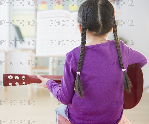 Chinese girl playing guitar