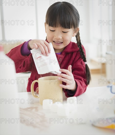 Chinese girl making hot chocolate