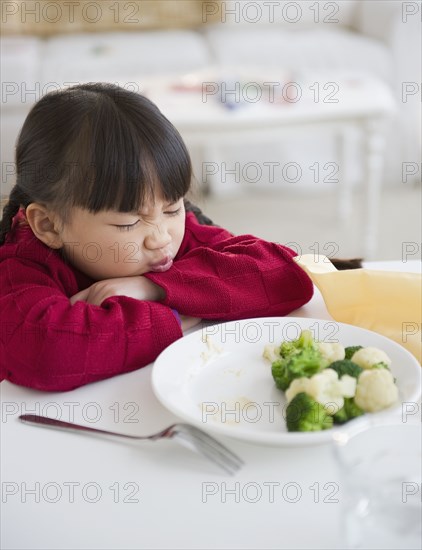 Chinese girl refusing to eat vegetables