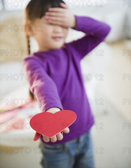 Chinese girl holding out Valentine