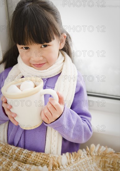 Chinese girl drinking hot chocolate