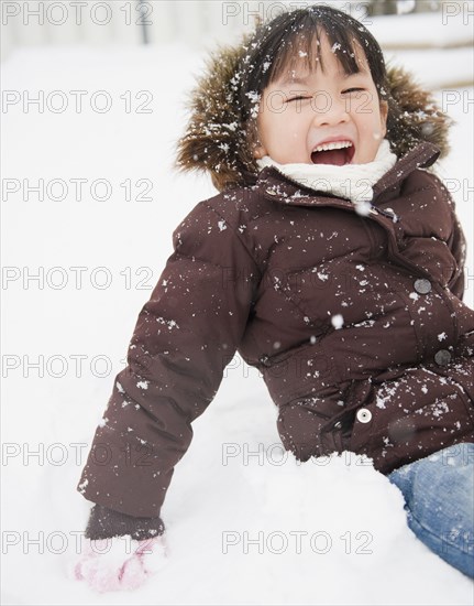 Chinese girl playing in snow