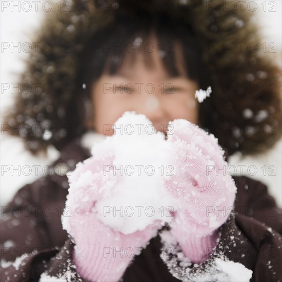 Chinese girl holding snowball