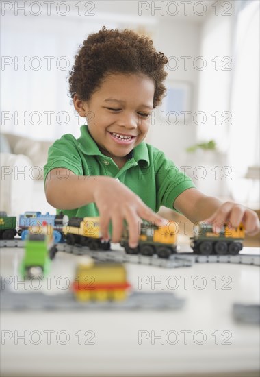 Black boy playing with toy trains