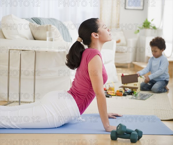 Mixed race mother practicing yoga