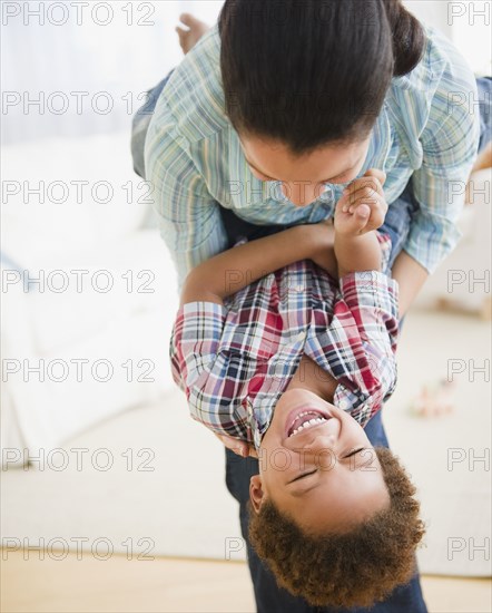 Mixed race mother playing with son