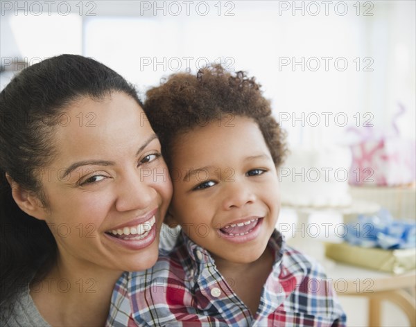 Mixed race mother smiling with son