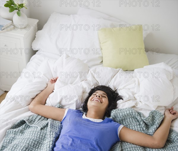 Hispanic woman laying on bed