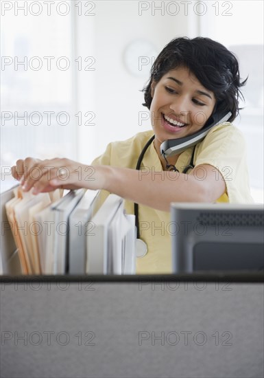 Hispanic nurse talking on telephone