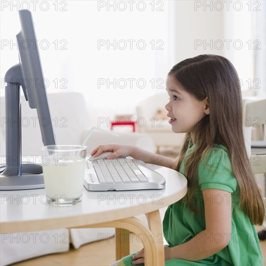 Mixed race girl using computer