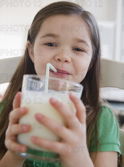 Mixed race girl drinking milk